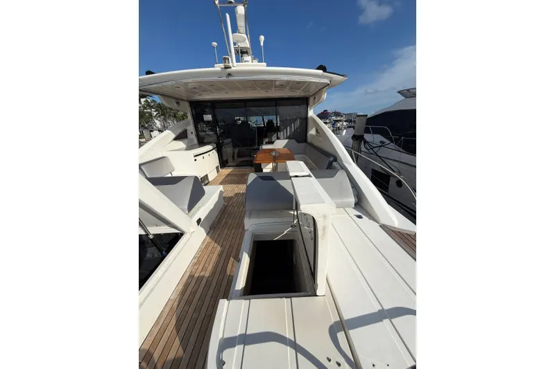 Slide: The Image of Luxurious 2005 Princess V70 yacht deck with seating and table under clear blue sky. - 20
