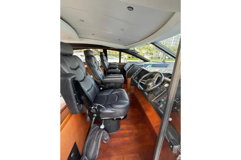 Slide: The Image of Luxurious 2005 Princess V70 yacht interior with leather seating and modern dashboard. - 18