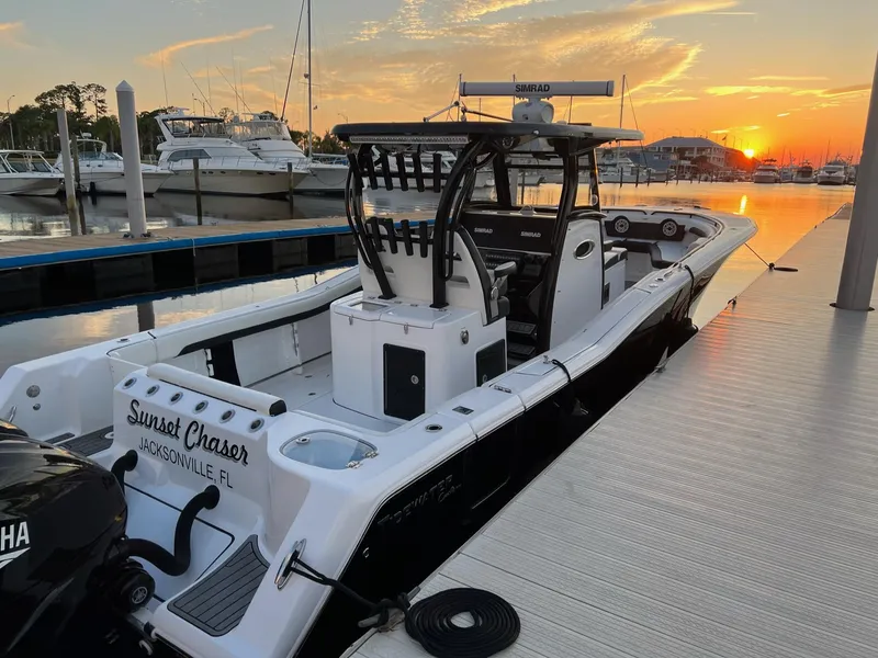 Slide: The Image of 2023 Tidewater 320 CC Adventure boat docked at sunset, Jacksonville marina. - 7