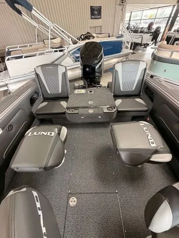 Slide: The Image of The image shows the interior of a 2027 Lund 1875 Tyee SS boat with gray seating. - 13