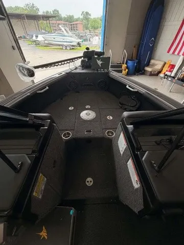 Slide: The Image of Interior of a Lund 1875 Tyee SS boat, featuring gray carpeting and multiple storage compartments. - 3