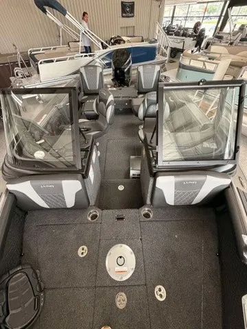 Slide: The Image of Interior view of a Lund 1875 Tyee SS boat with gray seating and carpeted flooring. - 6