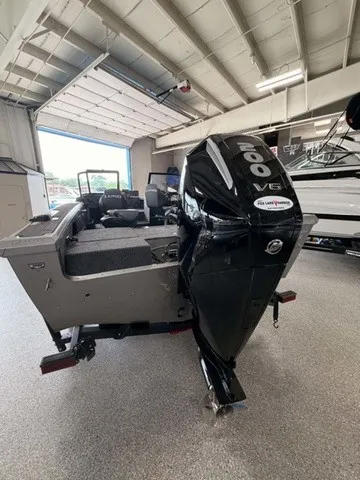 Slide: The Image of A 2027 Lund 1875 Tyee SS boat with a powerful outboard motor in a showroom. - 16