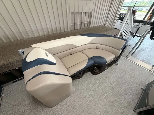 Slide: The Image of A sleek, modern boat with cream and blue upholstery in a spacious interior setting. - 3