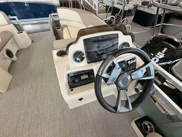Slide: The Image of The image shows the helm of a 2027 Avalon VEN 23E85 VRB boat with a modern steering wheel. - 8