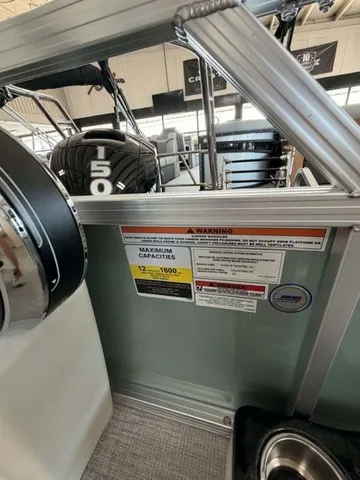 Slide: The Image of Interior view of a boat with engine and capacity warnings. - 9