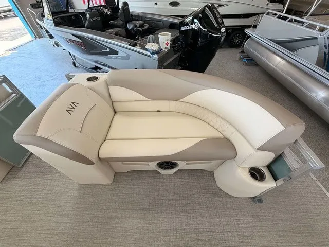 Slide: The Image of A sleek, cream-colored seating sofa with cup holders on a boat. - 4