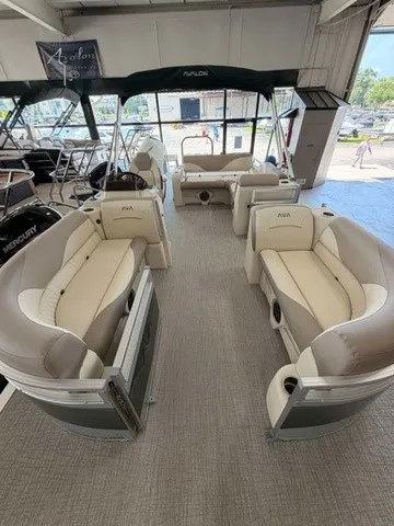 Slide: The Image of The image shows the interior of an Avalon VEN 23E85 VRB pontoon boat with beige seating. - 2