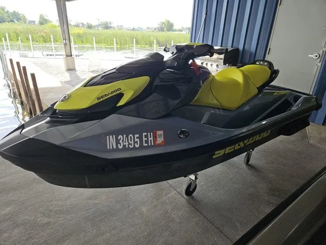 The Image of A 2021 Sea-Doo GTI SE 130 jet ski on a trailer in a covered area. - 1