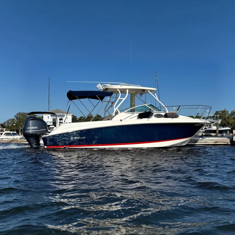The Image of 2014 Wellcraft 252 Coastal boat docked with Yamaha engine, blue and white design. - 0