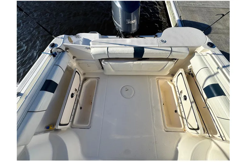 Slide: The Image of 2014 Wellcraft 252 Coastal boat deck with open storage compartments and Yamaha 300 engine. - 20