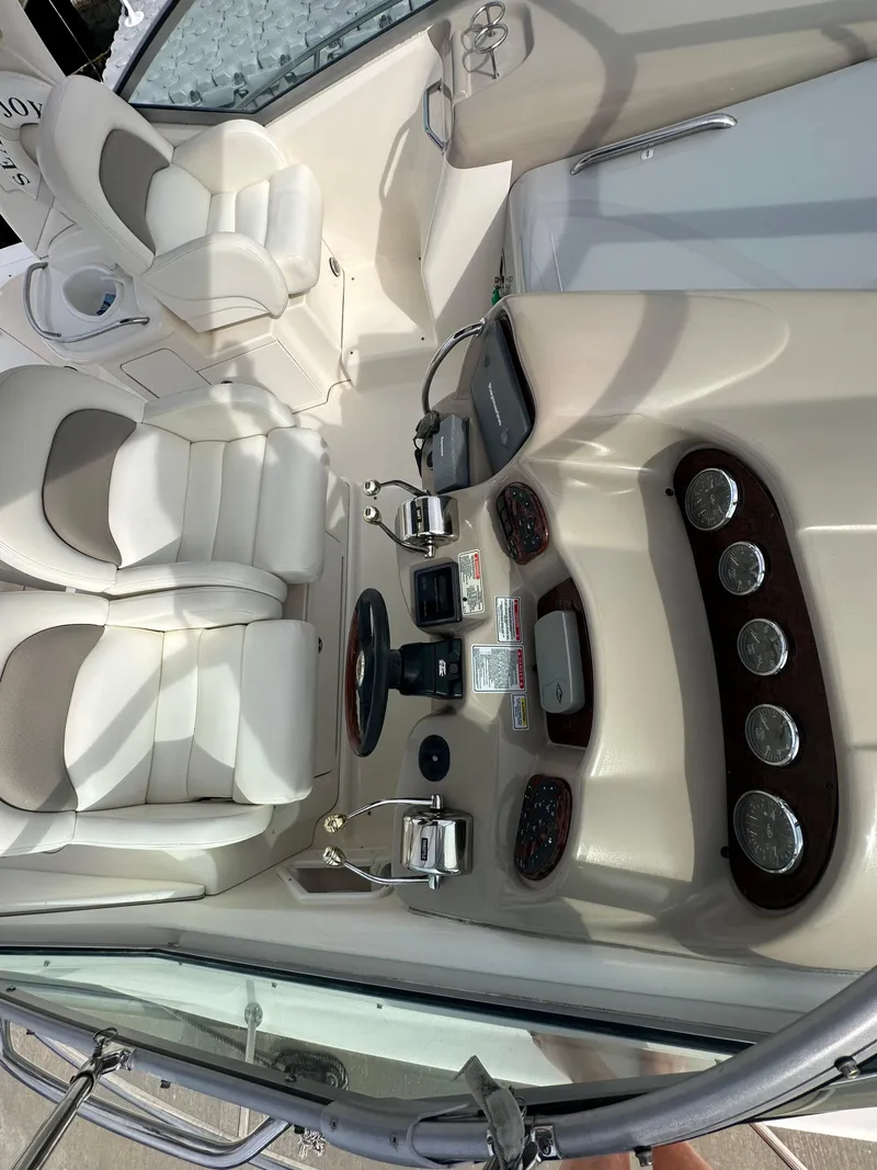 Slide: The Image of 2003 Sea Ray 340 Sundancer cockpit with dual seating and control panel. - 24