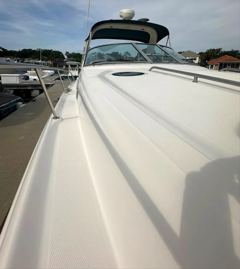 Slide: The Image of 2003 Sea Ray 340 Sundancer yacht docked at marina, view of bow and deck. - 17