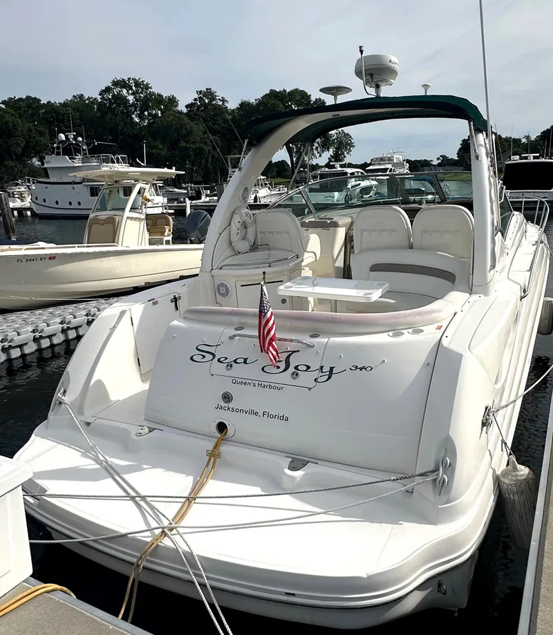 Slide: The Image of 2003 Sea Ray 340 Sundancer docked at a marina with an American flag. - 10