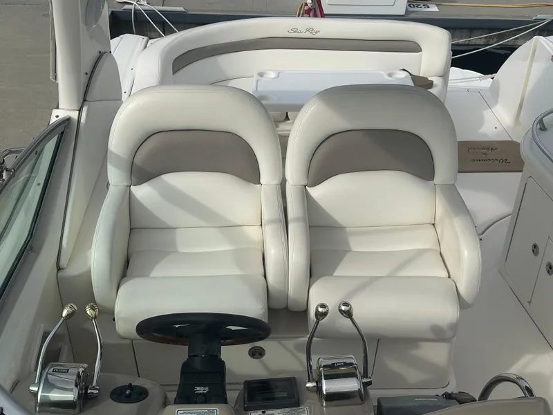 Slide: The Image of 2003 Sea Ray 340 Sundancer cockpit with dual white captain chairs. - 23