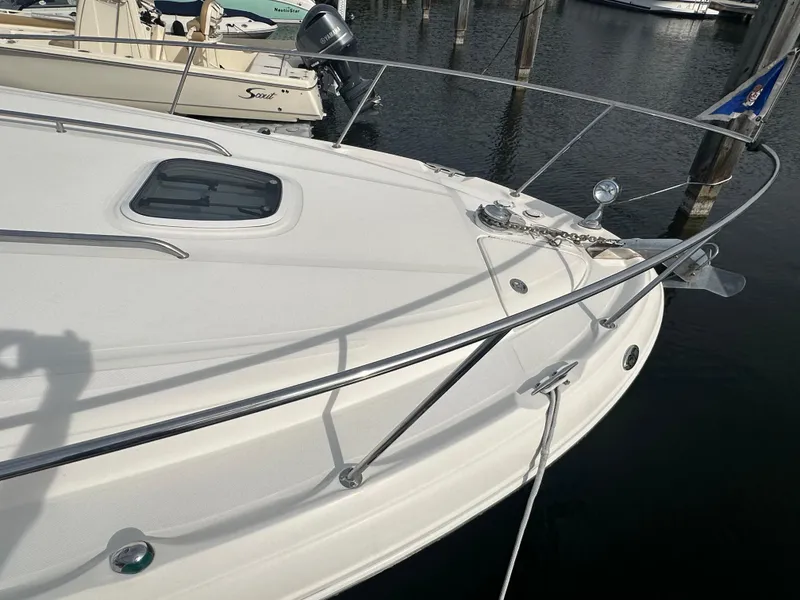 Slide: The Image of 2003 Sea Ray 340 Sundancer boat bow with anchor and railing in marina. - 13
