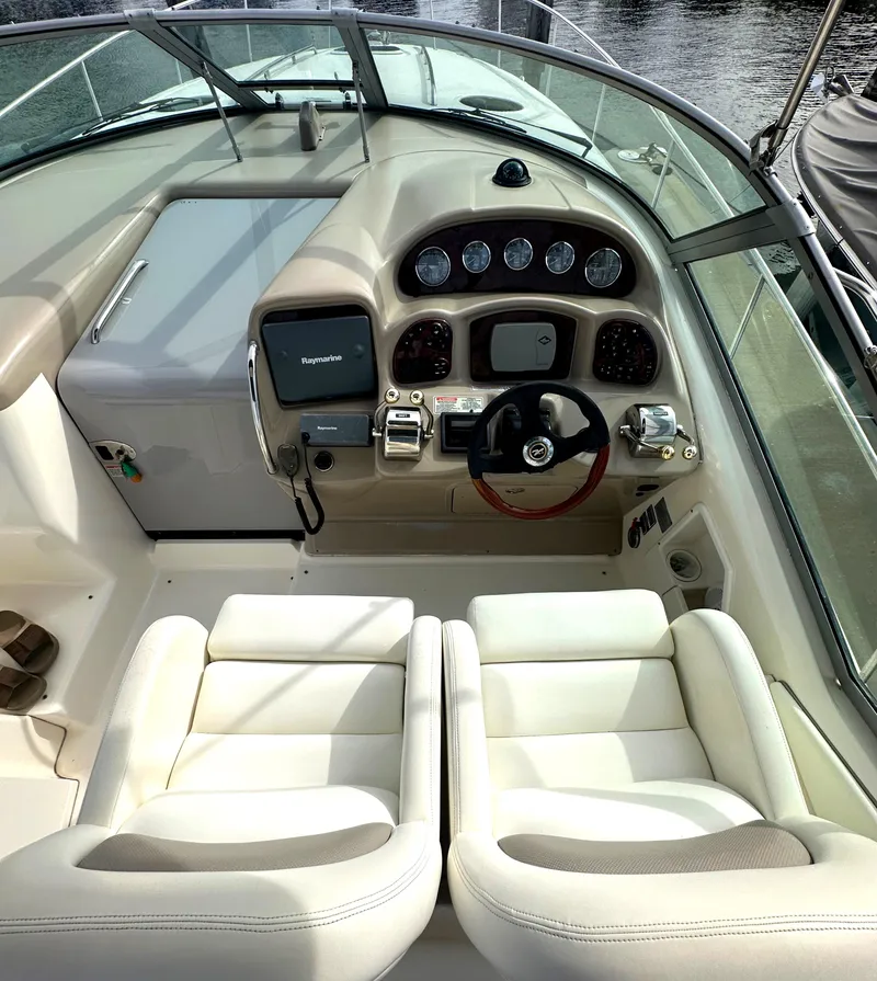 Slide: The Image of 2003 Sea Ray 340 Sundancer helm with dual seats and modern navigation equipment. - 36