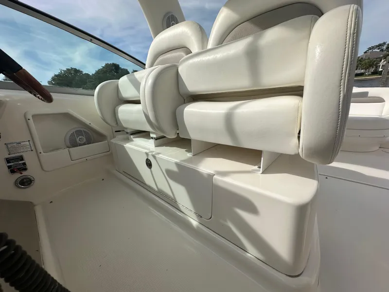Slide: The Image of 2003 Sea Ray 340 Sundancer cockpit seating and storage compartments. - 33
