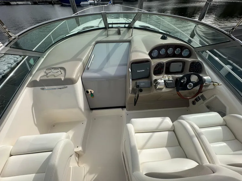 Slide: The Image of 2003 Sea Ray 340 Sundancer boat cockpit with steering wheel and control panel. - 35
