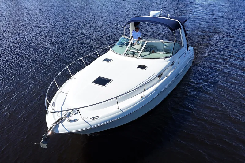 Slide: The Image of 2001 Sea Ray 340 Sundancer cruising on calm waters, featuring sleek design and spacious deck. - 3
