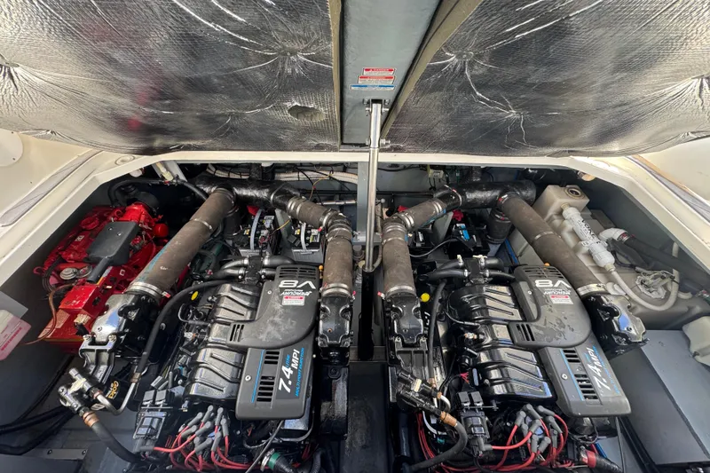 Slide: The Image of Engine compartment of a 2001 Sea Ray 340 Sundancer boat, showcasing dual engines. - 34