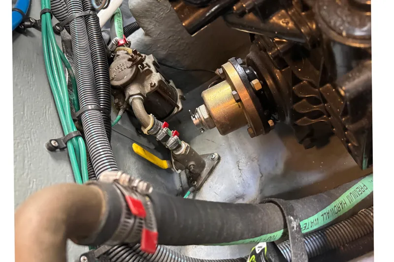 Slide: The Image of Engine compartment of a 2001 Sea Ray 340 Sundancer boat, showing mechanical components and wiring. - 46