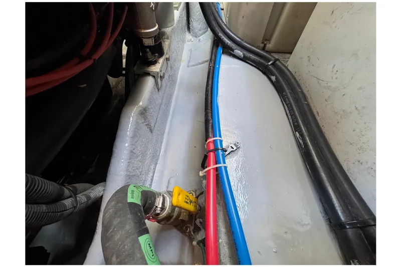 Slide: The Image of Engine compartment of a 2001 Sea Ray 340 Sundancer with visible hoses and wiring. - 48