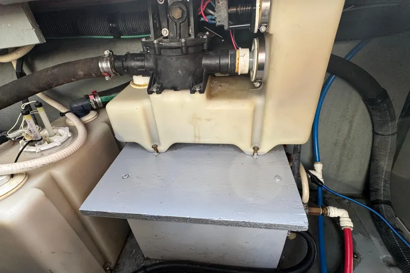 Slide: The Image of Engine compartment of a 2001 Sea Ray 340 Sundancer with visible plumbing and components. - 44