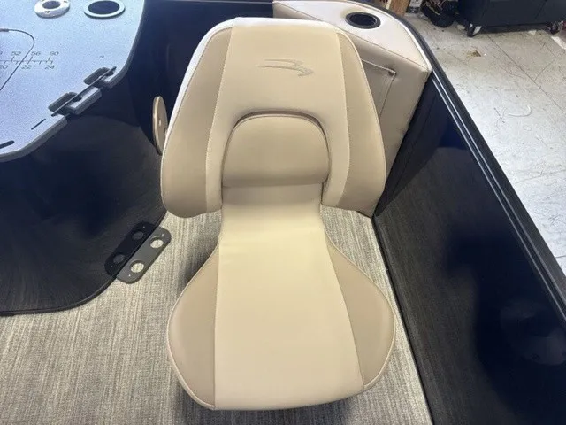 Slide: The Image of A beige boat seat with a stylized logo on the backrest, surrounded by gray flooring. - 16