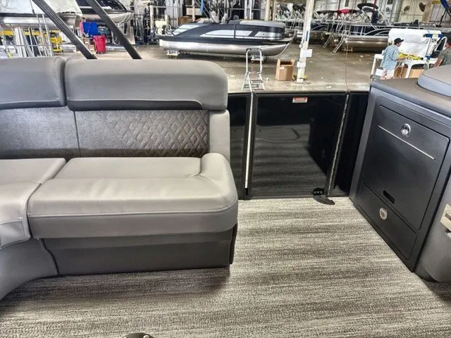 Slide: The Image of Interior of a Bennington M Fishing 22 MFC Tritoon with gray upholstery and carpeted floor. - 15