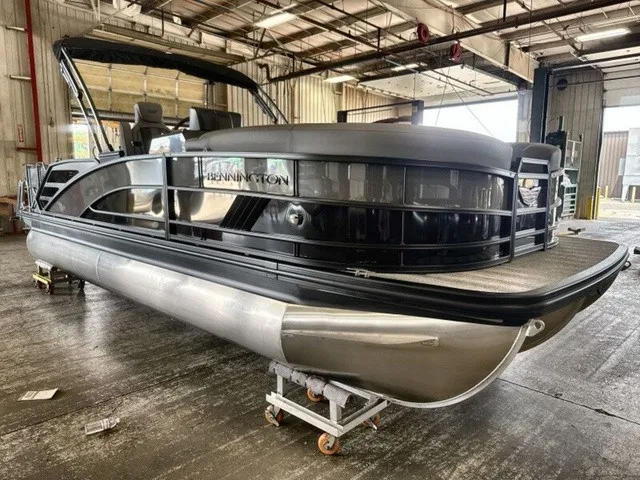 The Image of A modern 2027 Bennington M Fishing 22 MFC Tritoon is situated in a warehouse. - 1