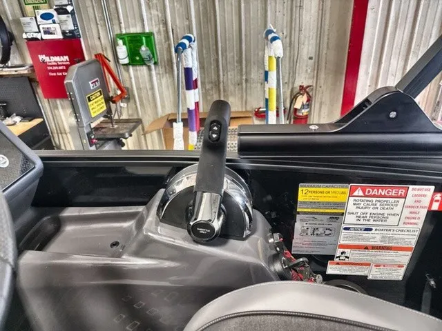 Slide: The Image of The image shows the helm of a Bennington M Fishing 22 MFC Tritoon with various warning labels. - 14