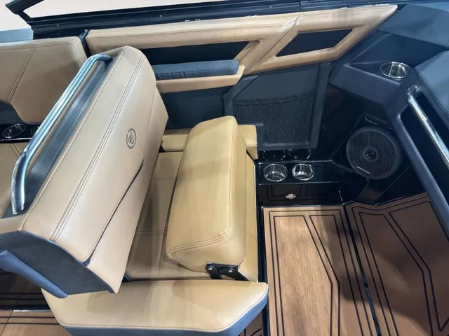 Slide: The Image of The image shows the interior of a 2027 Cobalt R4 Surf boat with beige leather seating. - 14
