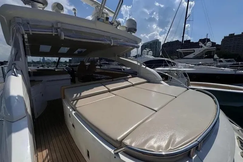 Slide: The Image of 2008 Princess V53 yacht with spacious sun deck, docked at marina under blue sky. - 24