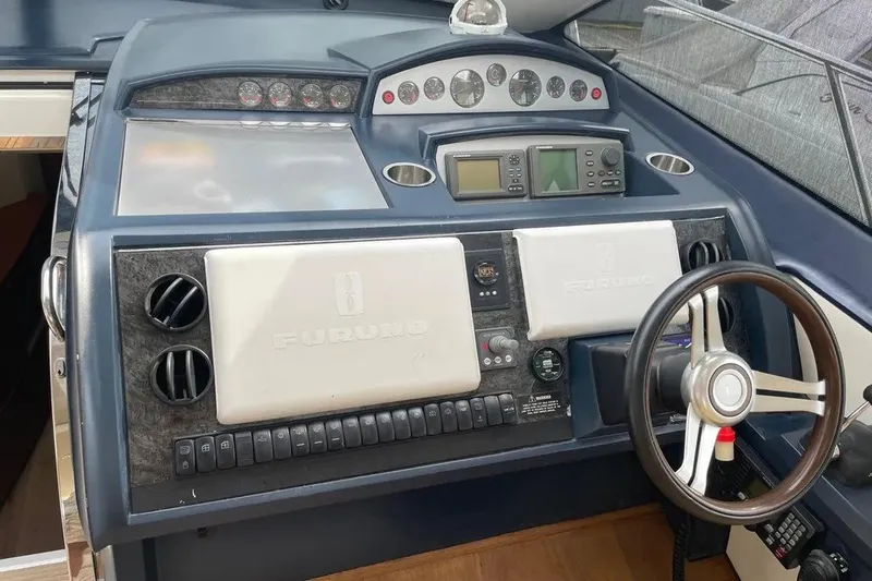 Slide: The Image of 2008 Princess V53 yacht dashboard with navigation instruments and steering wheel. - 43