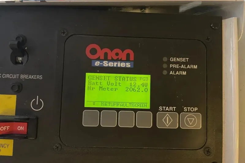 Slide: The Image of Onan e-Series genset control panel displaying battery voltage and hour meter. - 47