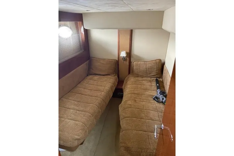 Slide: The Image of Cozy twin cabin in 2008 Princess V53 yacht with brown bedding and wall lamp. - 33