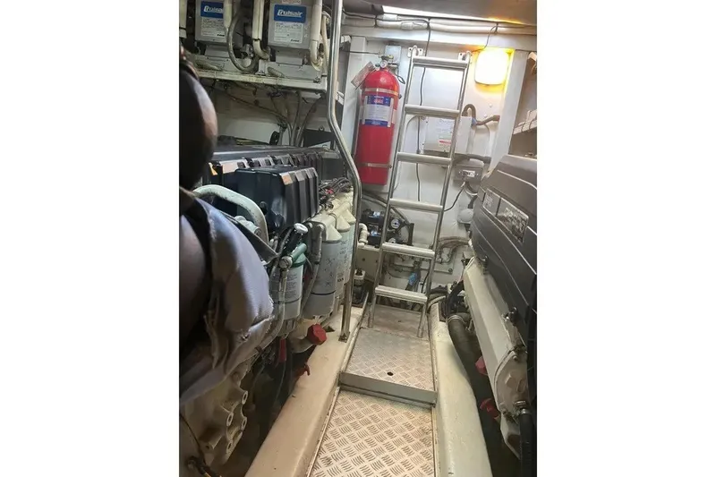 Slide: The Image of Engine room of a 2008 Princess V53 yacht, featuring machinery and safety equipment. - 28