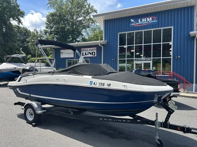 Slide: The Image of 2022 Bayliner VR5 Bowrider OB on a trailer in front of a blue building. - 17