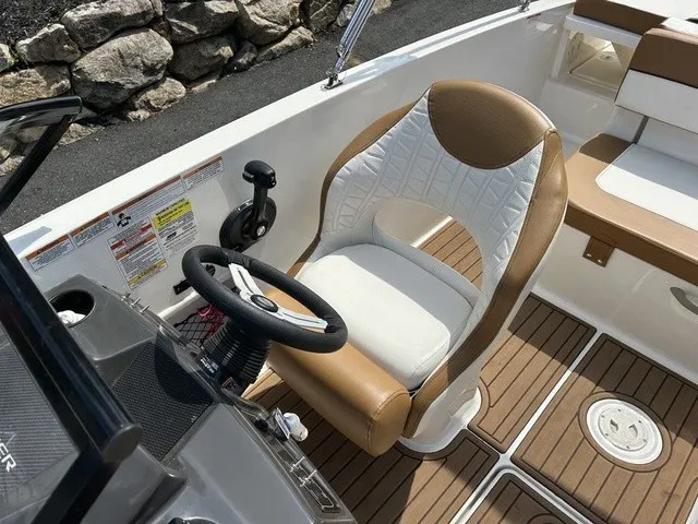 Slide: The Image of The image shows the helm of a 2022 Bayliner VR5 Bowrider OB with a cushioned seat. - 15