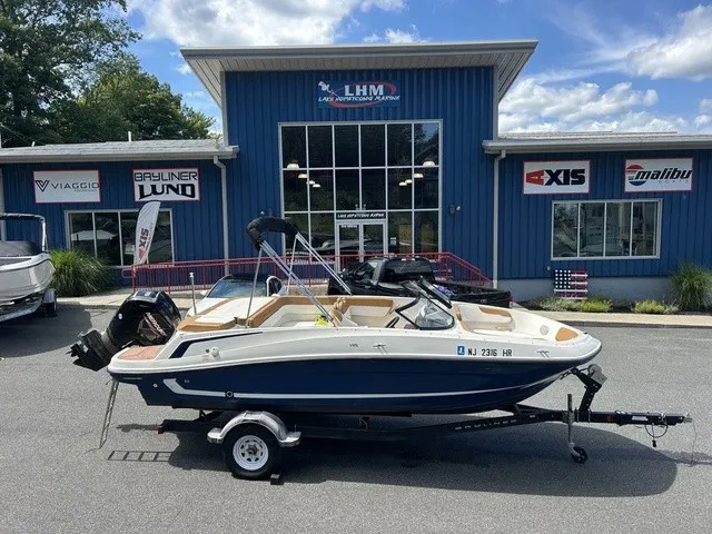 The Image of A 2022 Bayliner VR5 Bowrider OB on a trailer in front of a blue building. - 1
