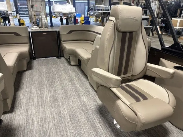 Slide: The Image of Interior of a Bennington S Quad Bench 22 SSR Tritoon with beige upholstery and carpeted floor. - 14