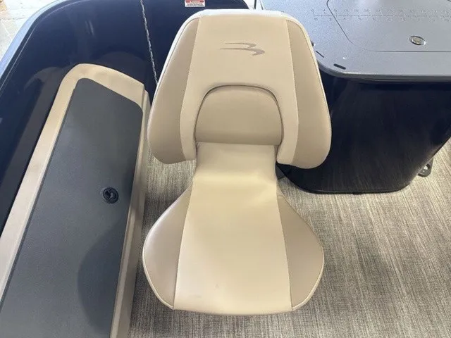 Slide: The Image of A beige boat seat with ergonomic design on a gray carpeted floor. - 17