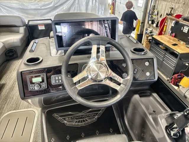 Slide: The Image of The image shows the helm of a Bennington M Fishing 22 MFC Tritoon with modern controls. - 13