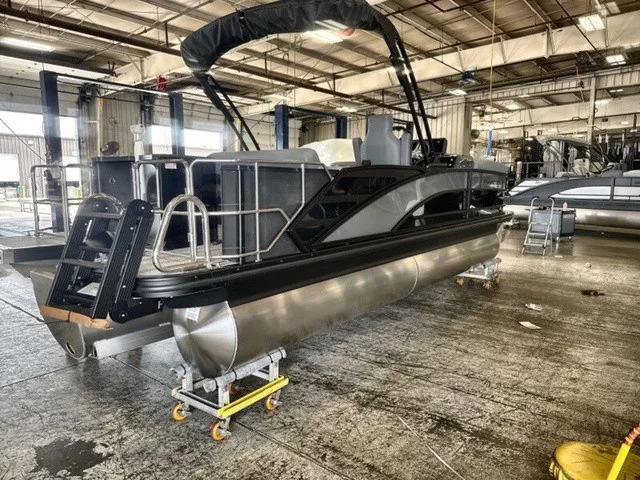 Slide: The Image of A 2027 Bennington M Fishing 22 MFC Tritoon is in a warehouse on dollies. - 8