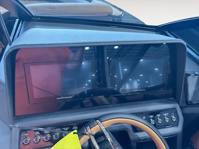 Slide: The Image of The image shows the dashboard of a Cobalt R4 Surf boat with two screens and a steering wheel. - 12