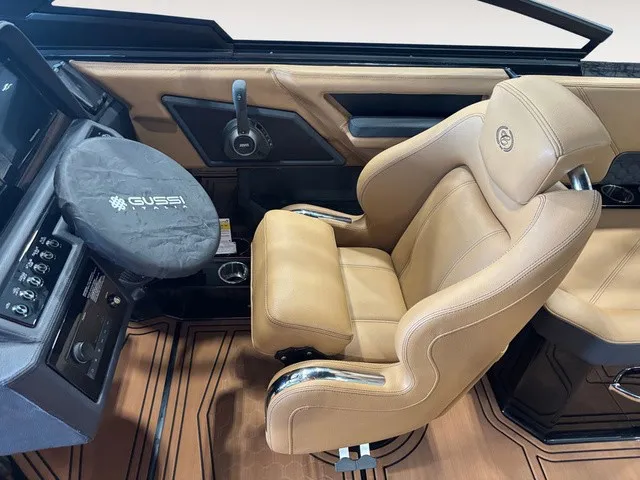 Slide: The Image of The image shows the driver's seat of a 2027 Cobalt R4 Surf boat with beige leather and modern controls. - 11