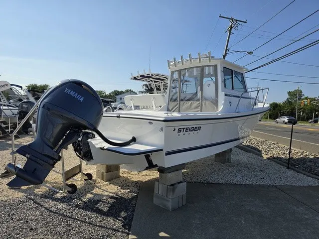 Slide: The Image of A 2027 Steiger Craft 21 Miami boat on blocks. It features a Yamaha outboard motor. - 2