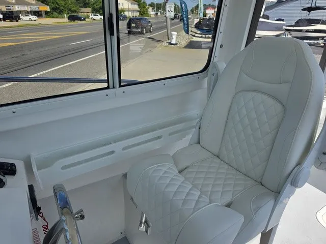 Slide: The Image of The image shows the interior of a 2027 Steiger Craft 21 Miami boat with a cushioned seat. - 6