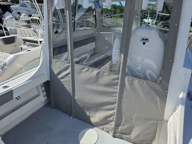 Slide: The Image of The image shows the cockpit of a Steiger Craft 21 Miami boat with gray upholstery. - 10
